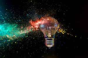 Light bulb exploding with colorful powder 
