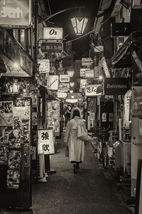 Woman walking through alley in shinjuku