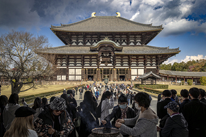 Tourists burning incense at todaiji temple in nara 