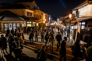 Crowd walking in a busy illuminated street at night in japan