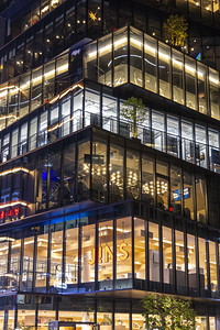 Modern glass office building exterior at night tokyo