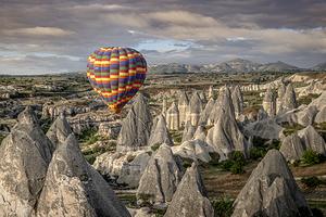 Colorful hot air balloon flying over the unique rock formations 