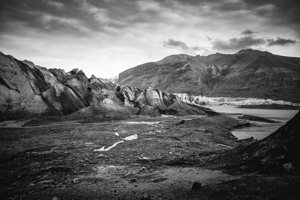 Dramatic landscape showing melting glacier with volcanic ash