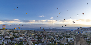 Colorful hot air balloons flying over the rocky landscap
