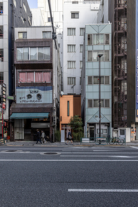 Pedestrians walking on the sidewalk in tokyo japan passing by 
