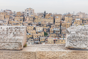 Amman city skyline rising above ancient roman ruins of the amman