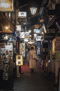 Woman walking through alley in shinjuku