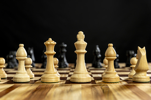 Chess pieces on wooden chessboard 