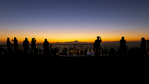 Tourists relaxing  rooftop panoramic view tokyo cityscape 