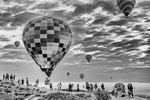 Tourists watching hot air balloons floating over cappadocia at s