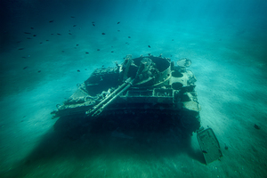 Old military tank lies decaying on the seabed creating an artif