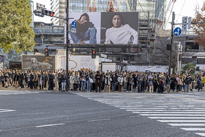Tourists and citizens waiting to cross a street at a famous inte