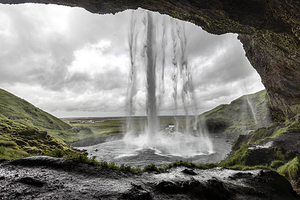 Seljalandsfoss waterfall crashing down on a cloudy day in icelan