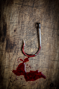 bloody steel hook on wooden bottom