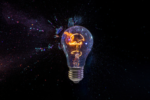 old bulb breaking into fragments on black 