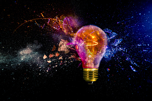 Exploding light bulb with colorful sparks