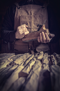 carpenter holding a planer