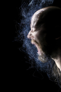 portrait of a person screaming in motion with lights creating pa