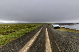 Dacia duster  parked dirt road vast grassy plain that leads bod