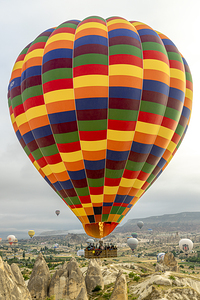hot air balloons fly over the city of goreme.