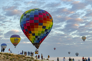 ot air balloon flies low over the city of goreme 