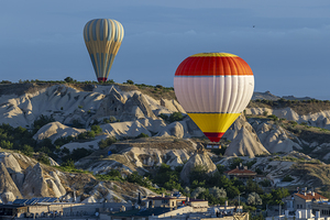 hot air balloons fly over the city of goreme