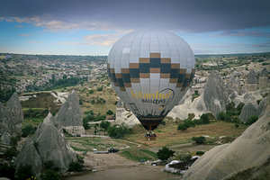 hot air balloons fly over the city of goreme.