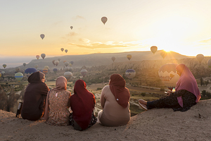 group of women enjoying the hot air balloon show at dawn