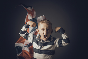 portrait of jubilant child and English flag