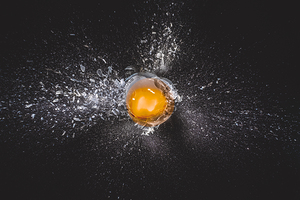 Explosion of glass ball and egg yolk 