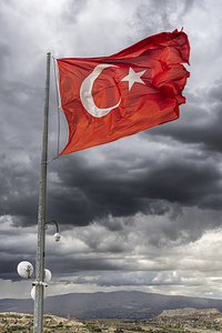 turkey flag flying over the city of goreme