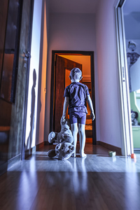 child with teddy bear in a domestic place