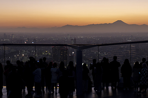 crowds of people admire the view from the Shibuya Sky Tower