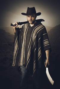 portrait of man with leather hat and machete
