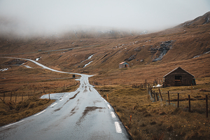 Image of travel on a lonely road in the Faroe Islands. 