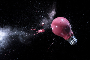 explosion of a red light bulb on black.