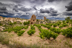 view of red valley in turkey with cloudy sky and building carved