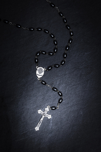 rosary with crucifix on black slate 