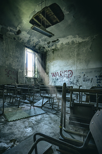 old  and vandalised interior of a school classroom