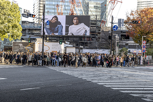 crowds of people prepare to cross the famous Shibuya Crossing