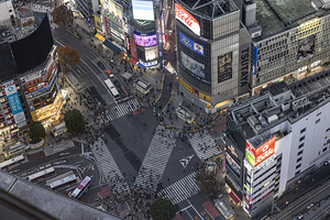 crowds of people prepare to cross the famous Shibuya Crossing ae