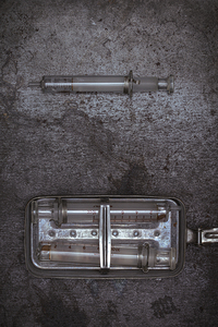 old glass syringes in metal box 