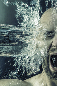 portrait of a man receiving a bucket of water in his face