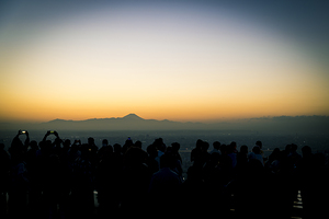 people wait for the sunset and photograph the city of Tokyo with