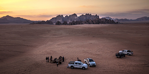tourists in the wadi rum desert at sunset