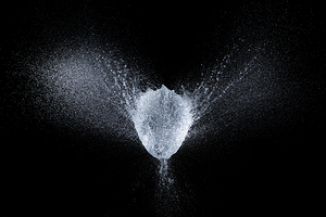 balloon explosion filled with water at the exact moment of the e