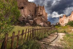 cave and rock formations wooden fence in the zelve valley cappa