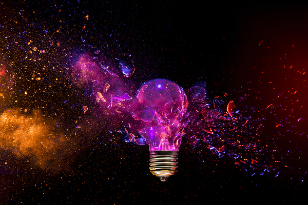 Exploding light bulb concept on dark background Print
