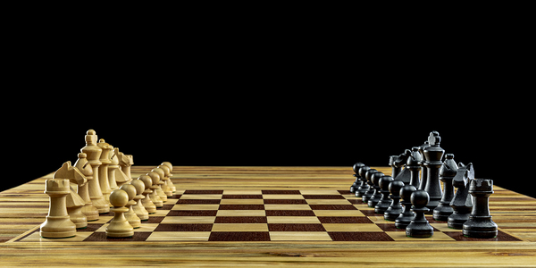 Wooden chess pieces standing on chessboard Print