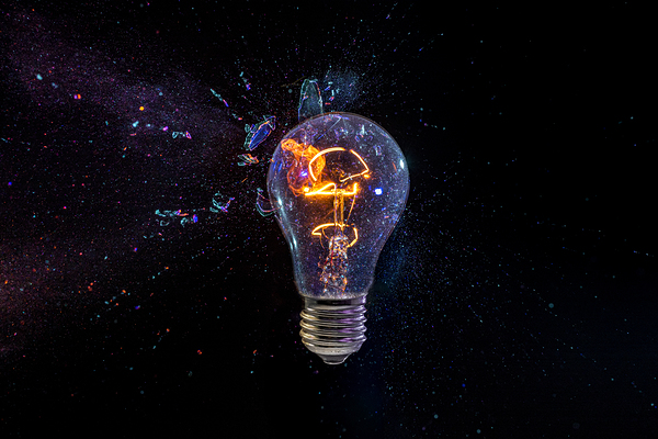 old bulb breaking into fragments on black  Print